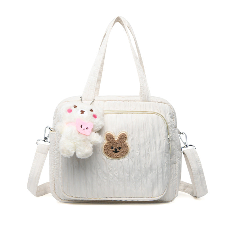 sac-pour-bebe-avec-pendentif-couleur-blanche